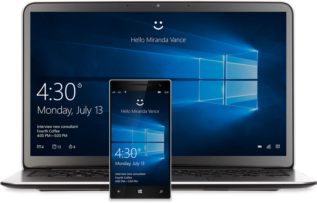 A laptop and phone with the Windows 10 Start screen on the display. There’s a smiley face at the top of each above the words, “Hello Miranda Vance”