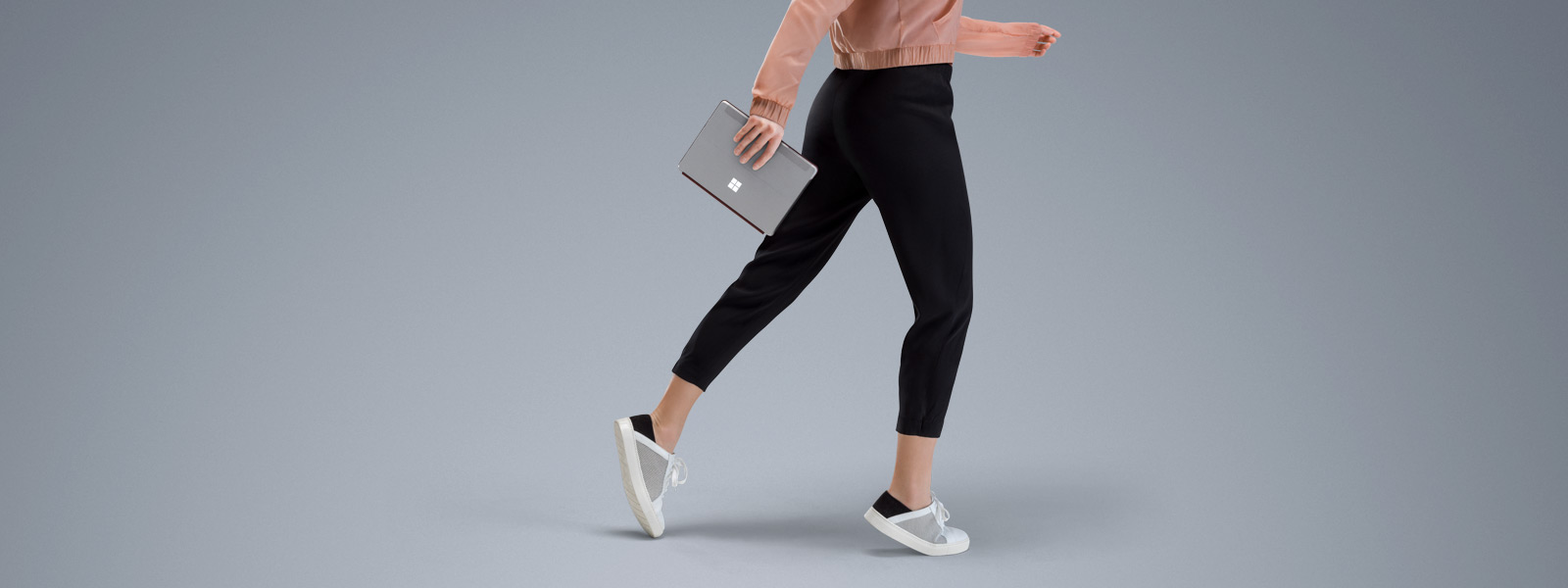 Surface Go held by a girl walking