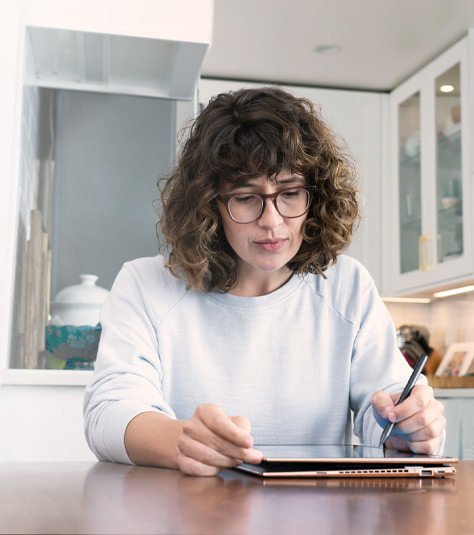 Woman draws with a digital pen on a tablet computer
