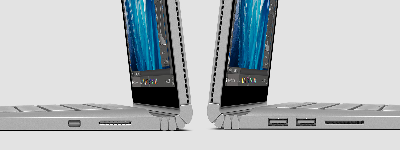 Two Surface Books back to back, as seen from the side with detail of the hinge and external ports
