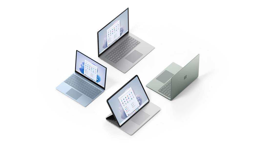 A group of the Surface family of laptops. Clockwise from top: 15” Surface Laptop 5 in platinum, 13.5” Surface Laptop 5 in sage, Surface Laptop Studio in stage mode, Surface Laptop Go 2 in Ice Blue.