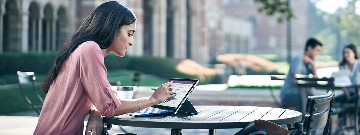 Woman using Surface Pen on Surface Pro 4 in an outdoor setting