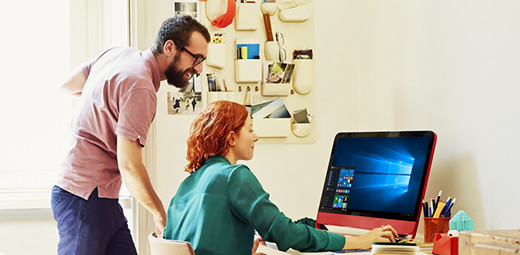 Two people looking at a Windows 10 all-in-one