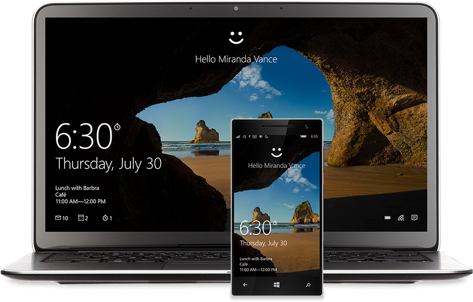 A laptop and phone with the Windows 10 Start screen on the display. There’s a smiley face at the top of each above the words, “Hello Miranda Vance”