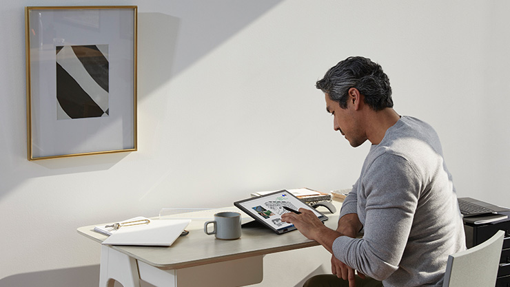 Un homme effectue une entrée manuscrite à l’aide d’un stylet pour Surface sur sa Surface Pro